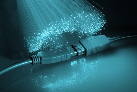 USB plugs and sockets closeup with blue fiber background