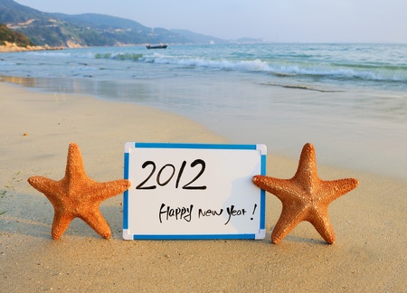2012 happy new year message on the sand beach