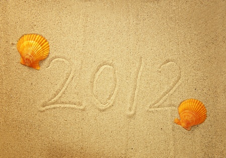 Numbers 2012 on tropical beach sand with shell 
