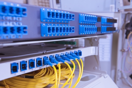 closeup of fiber optical network hub and cables
