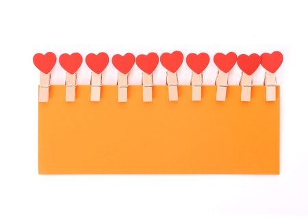 clothes pegs with heart isolated on white backgroundの写真素材