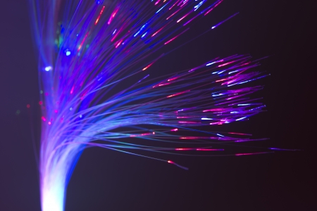 bunch of optical fibres dinamic flying from deep on technology backgroundの写真素材