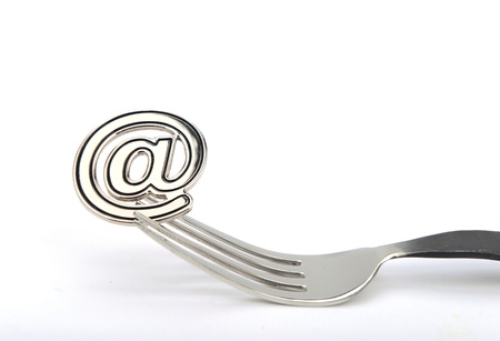 email symbol on a fork isolated on white backgroundの写真素材