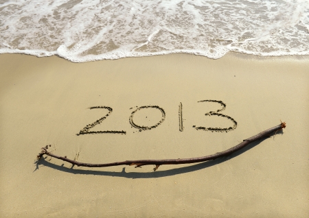 New year background with "2013" drawn in the sandの写真素材