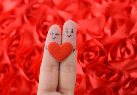 happy couple in love with painted smiley and huggingの写真素材