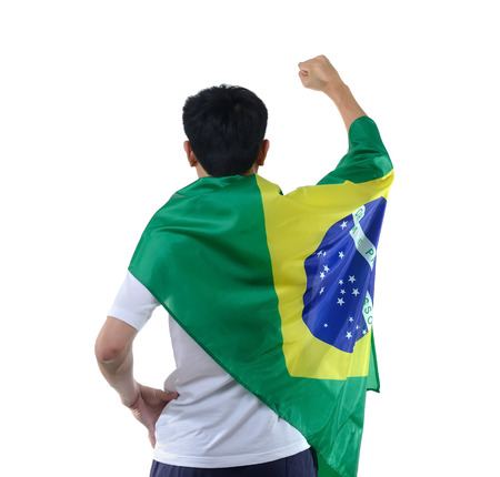 Brazilian man celebrates with flag and maskの写真素材