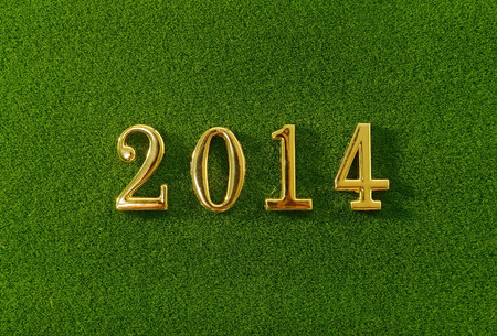 2014 message make of metal numbers on grass backgroundの写真素材