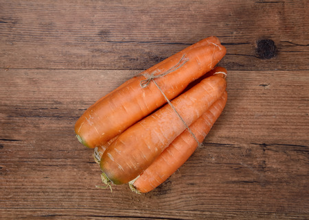 Organic raw carrots of rustic woodの写真素材