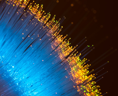 bunch of optical fibres dinamic flying from deep on technology backgroundの写真素材