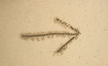 Drawn arrow on the sandの写真素材