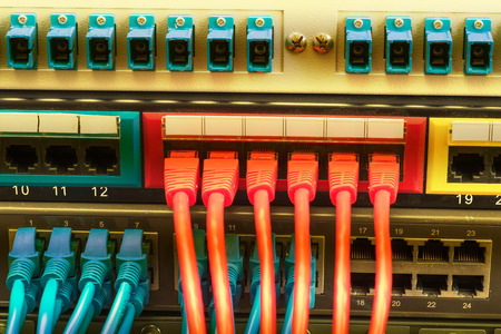 network cables and hub closeup with fiber optical background