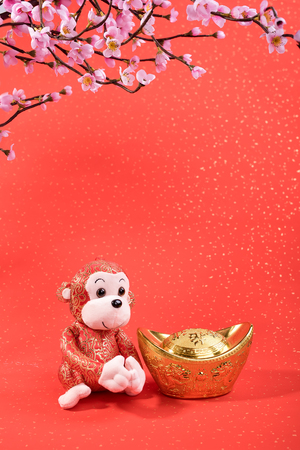 Chinese lunar new year ornaments toy of monkey on festive backgroundの写真素材