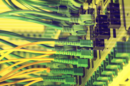 Fiber Optic cables connected to an optic ports and Network cables connected to the ports
