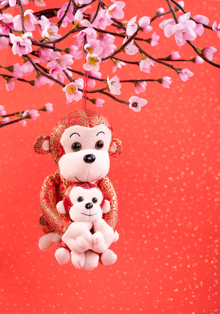 Chinese lunar new year ornaments toy of monkey on festive backgroundの写真素材