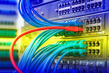 network cables and hub closeup with fiber optical background