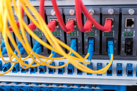 Fiber Optic cables connected to an optic ports and Network cables connected to ports