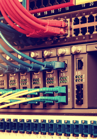 Fiber Optic cables connected to an optic ports and Network cables connected to ethernet ports