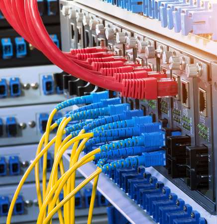 Fiber Optic cables connected to an optic ports and Network cables connected to ports