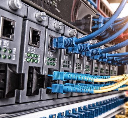 Fiber Optic cables connected to an optic ports and Network cables connected to ethernet ports