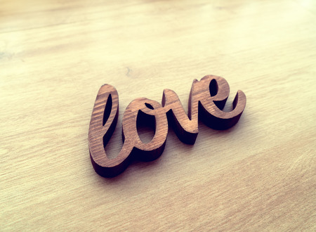 Wooden letters forming word LOVE written on wooden backgroundの写真素材
