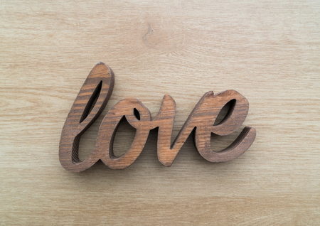 Wooden letters forming word LOVE written on wooden backgroundの写真素材