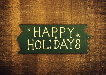 happy Holiday written on wooden backgroundの写真素材