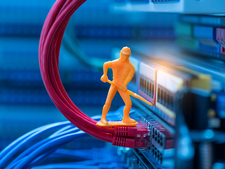 Miniature Technicians connecting network cableのeditorial素材