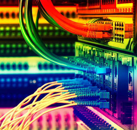 Fiber Optic cables connected to an optic ports and Network cables connected to portsのeditorial素材