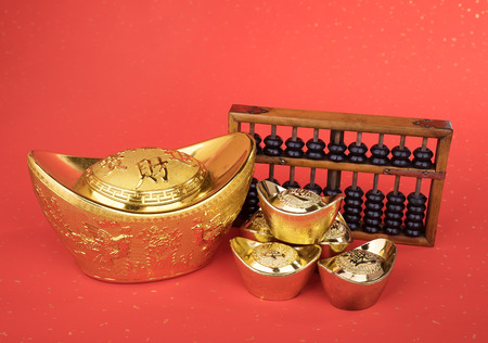 Chinese gold ingot and abacus mean symbols of wealth and prosperity.の写真素材