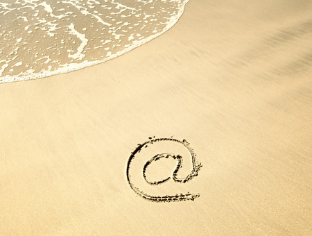 Email symbol draw on beachの写真素材