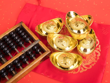 Chinese gold ingot and abacus mean symbols of wealth and prosperity.の写真素材