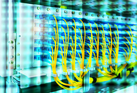 Fiber Optic cables connected to an optic ports and Network cables connected to ports