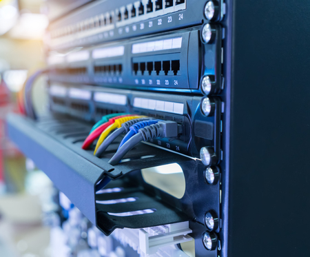 network cables and hub closeup with fiber optical background