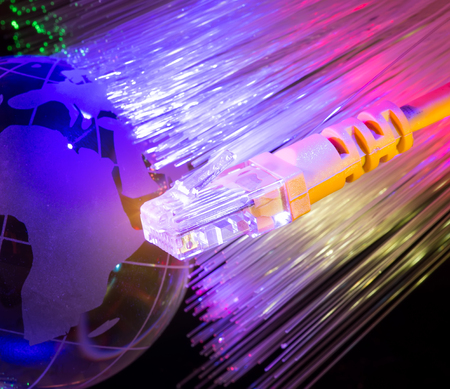 glass earth with network against fiber optic backgroundの写真素材