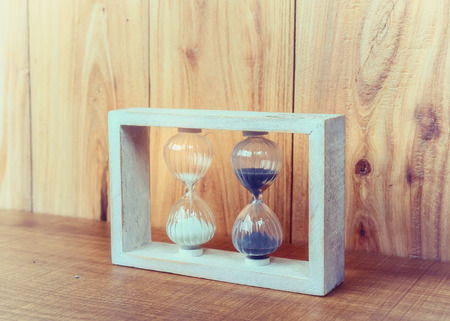 Hourglass on wooden background