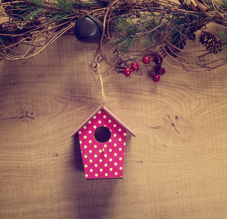 birdhouse hang on spring tree flowers with antique rustic wood background.の写真素材