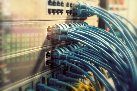 Network cables in switch and firewall in cloud computing data center server rackの写真素材