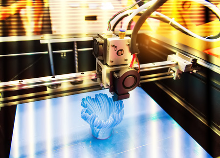 Modern 3D printer printing figure close-up macro