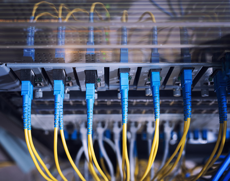 Fiber Optic cables connected to an optic ports and Network cables connected to ports