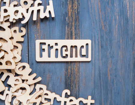 Word made of wooden letters and Pile of wooden block letters on blue wood backgroundの写真素材