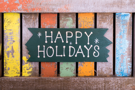 happy Holiday written on wooden backgroundの写真素材