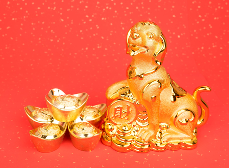 Chinese new year decoration:golden dog statue and gold ingots,translation of calligraphy: 2018 is year of the dog,red stamp: good Fortune for new yearの写真素材