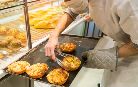 Baker holding freshly baked breadの写真素材