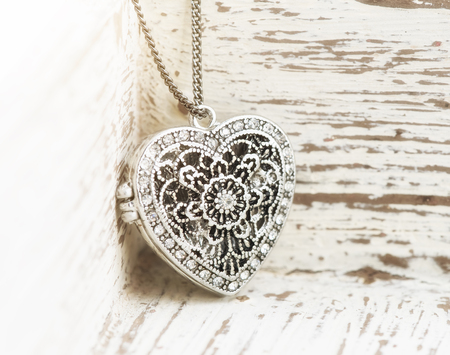 heart shaped pendant on pink backgroundの写真素材