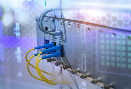 Fiber Optic cables connected to optic ports and UTP, Network cables connected to ports.