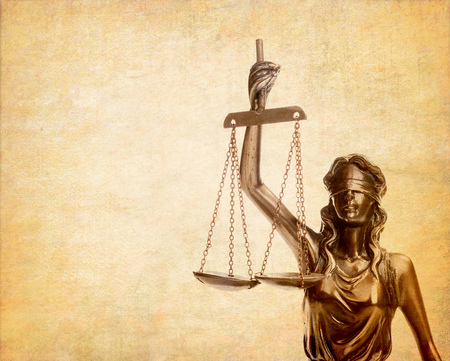 Statue of justice on old paper background, law conceptの写真素材