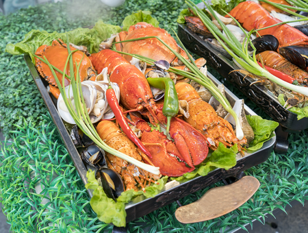 Shellfish plate of crustacean seafood with fresh lobster as an ocean gourmet dinnerの写真素材