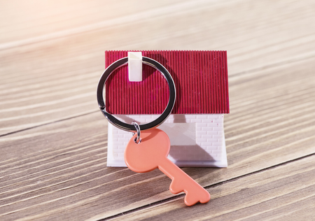 keychain with house symbol and keys on wooden background,Real estate conceptの写真素材