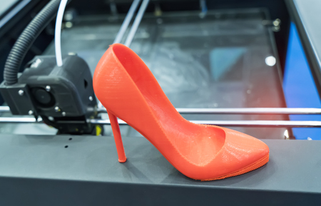 3D printer printing high heeled shoe figure close-up.の写真素材