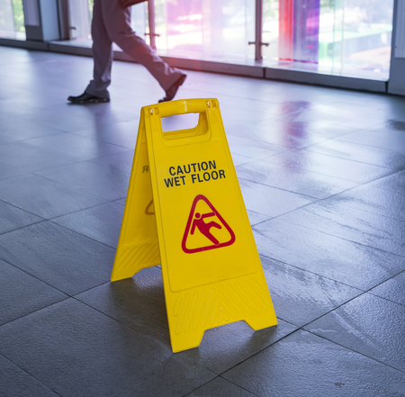 Yellow Caution wet floor sign on wet floorの写真素材